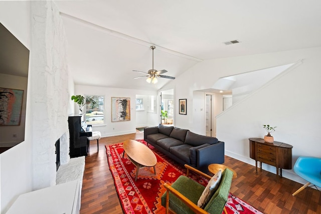 living room featuring wood finished floors, baseboards, visible vents, vaulted ceiling with beams, and a large fireplace