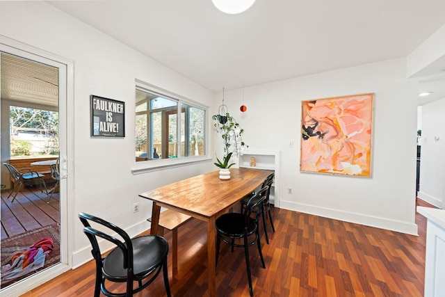 dining space with plenty of natural light, baseboards, and wood finished floors