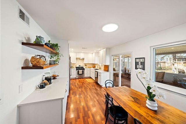 dining room featuring light wood finished floors and visible vents