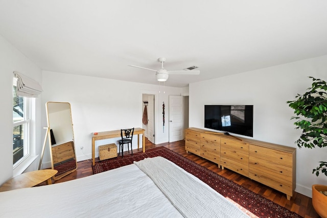 bedroom with visible vents, ceiling fan, baseboards, and wood finished floors