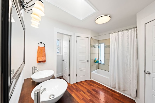 full bath with shower / bath combination with curtain and wood finished floors