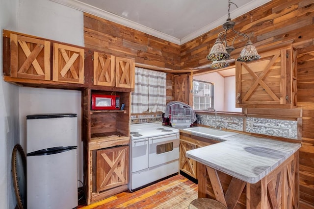 kitchen featuring ornamental molding, a sink, light countertops, light wood-style floors, and white electric range