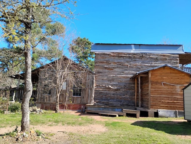 view of side of property with a lawn