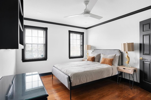 bedroom featuring baseboards, a ceiling fan, wood finished floors, and crown molding