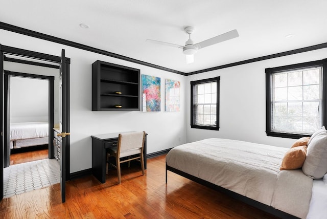 bedroom with baseboards, ceiling fan, crown molding, and light wood finished floors