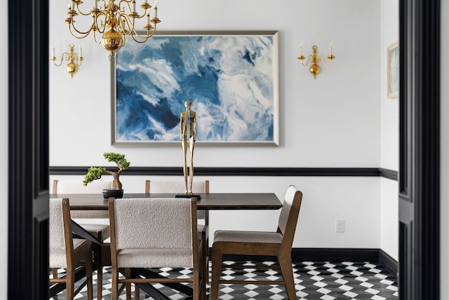 dining area with baseboards and a chandelier