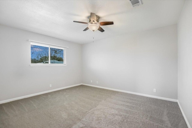 spare room featuring visible vents, ceiling fan, baseboards, and carpet