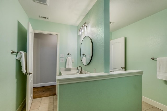 bathroom with tile patterned flooring, visible vents, vanity, and baseboards