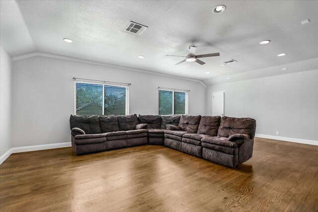 11402 Pencewood Dr, Austin, TX 78750 - living area featuring vaulted ceiling, a ceiling fan, wood finished floors, recessed lighting, and a textured ceiling
