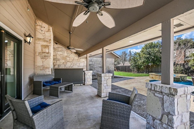 view of patio / terrace with ceiling fan, an outdoor living space, an in ground hot tub, and a fenced backyard