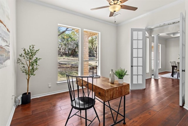 office with crown molding, decorative columns, baseboards, ceiling fan, and dark wood-style flooring