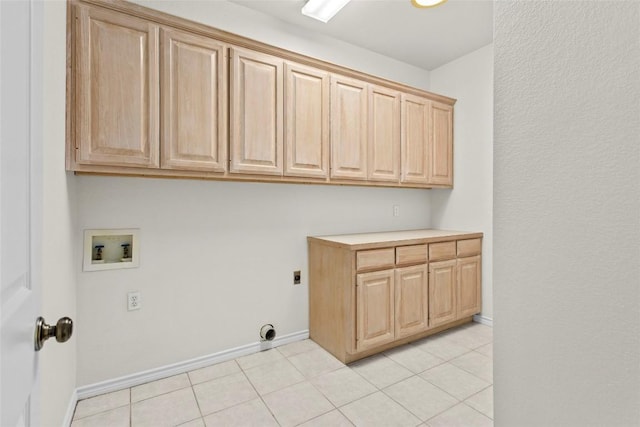 laundry room featuring light tile patterned floors, cabinet space, hookup for an electric dryer, and hookup for a washing machine