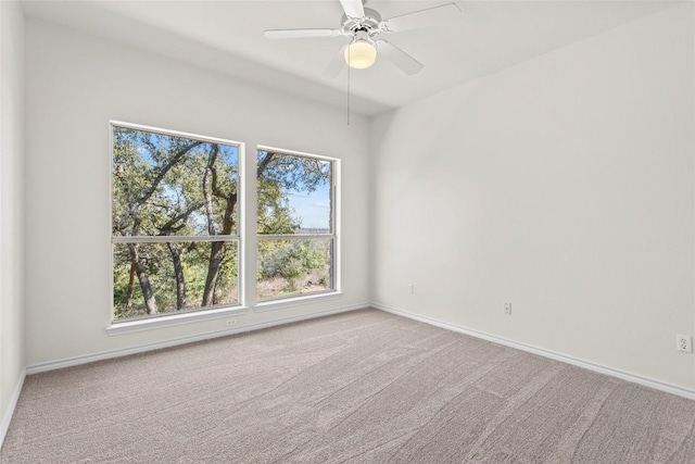 unfurnished room with baseboards, ceiling fan, and carpet flooring