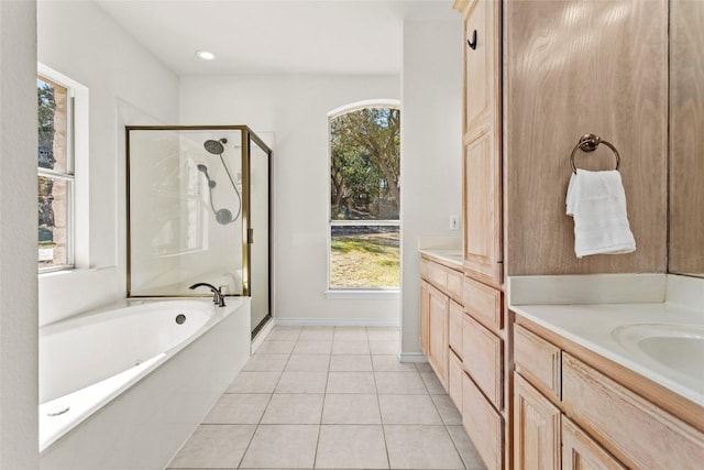 bathroom with tile patterned floors, a shower stall, vanity, and a garden tub