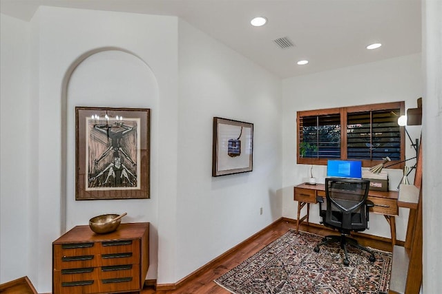 office featuring recessed lighting, visible vents, baseboards, and wood finished floors