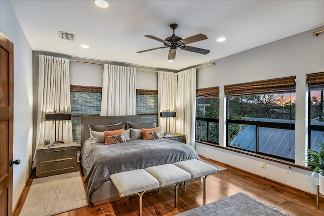 bedroom featuring recessed lighting, visible vents, baseboards, and wood finished floors