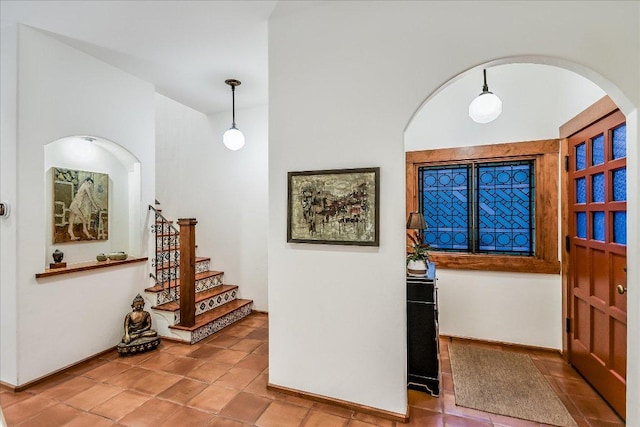 entrance foyer with stairs and tile patterned floors