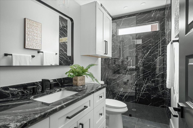 bathroom featuring vanity, toilet, tile patterned flooring, and a marble finish shower