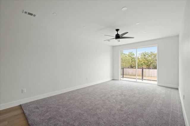 empty room featuring visible vents, baseboards, and a ceiling fan