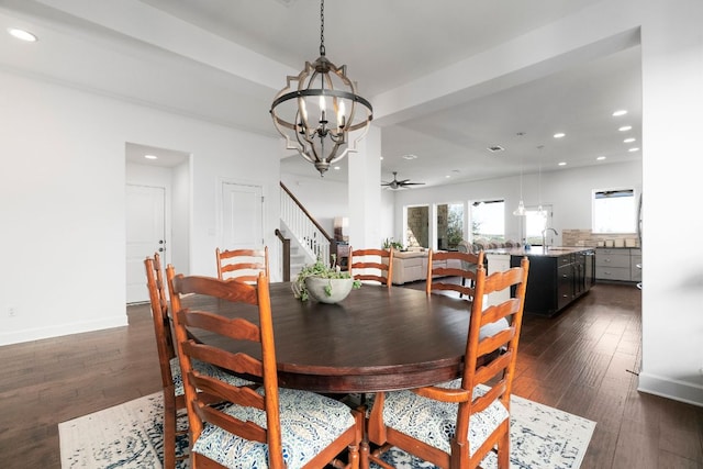 dining room featuring dark wood finished floors, recessed lighting, stairs, and baseboards