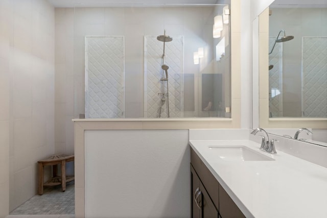 bathroom featuring a walk in shower and vanity