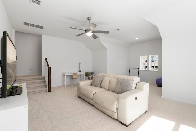 carpeted living area featuring visible vents and baseboards