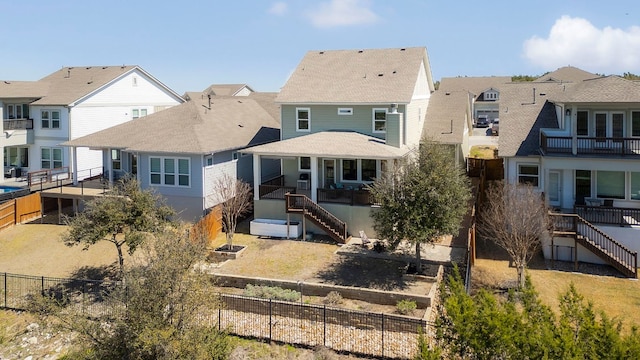 rear view of house with a residential view, stairs, and a fenced backyard