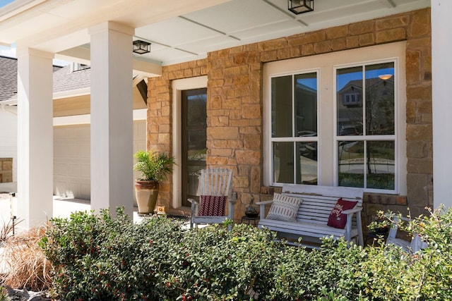 view of patio / terrace featuring a porch and an attached garage