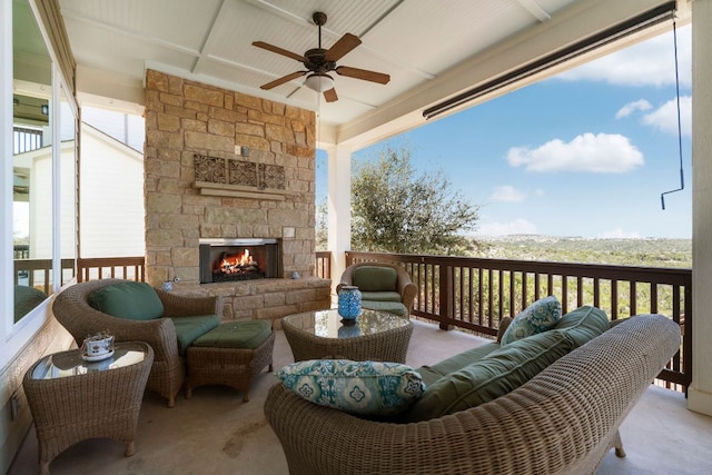 exterior space featuring an outdoor living space with a fireplace and a ceiling fan