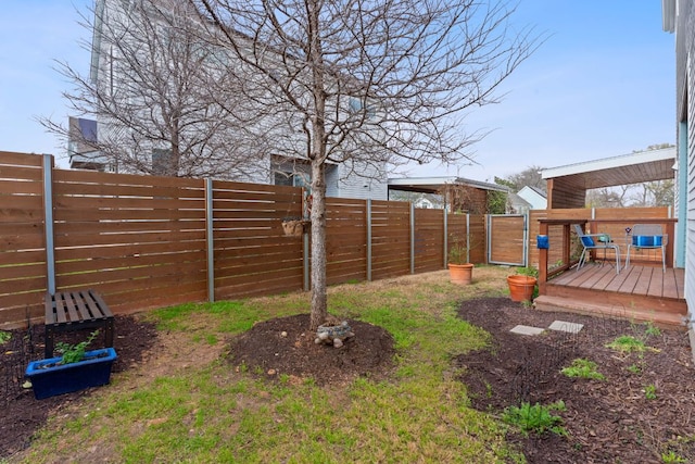 view of yard with a deck and a fenced backyard