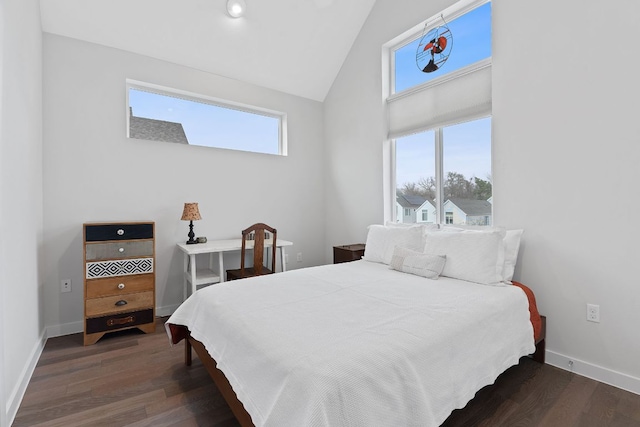 bedroom with dark wood-style floors, high vaulted ceiling, and baseboards