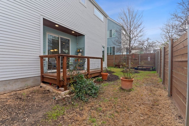 view of yard featuring a deck and a fenced backyard