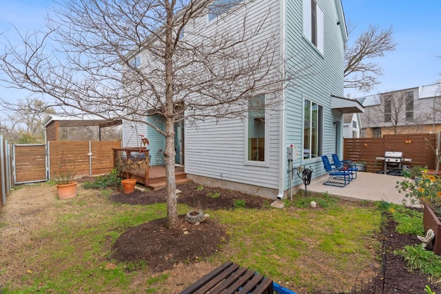 view of yard with a patio area, a deck, and fence