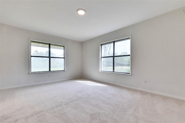 spare room featuring baseboards and carpet