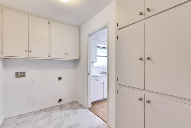 clothes washing area with baseboards, hookup for an electric dryer, cabinet space, washer hookup, and marble finish floor