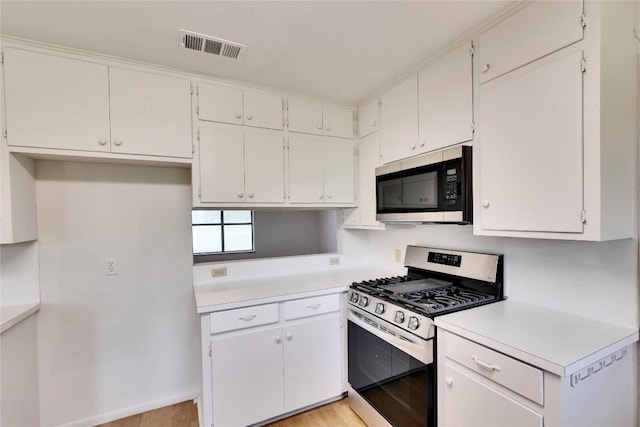 kitchen with visible vents, white cabinetry, appliances with stainless steel finishes, light wood finished floors, and light countertops