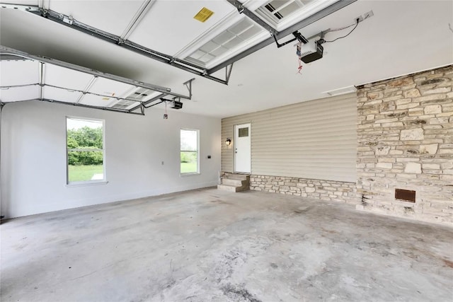 garage with a garage door opener and baseboards