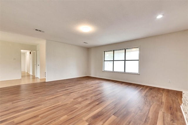 empty room featuring visible vents and wood finished floors