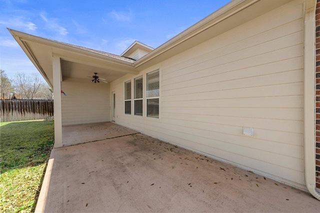 view of patio featuring a ceiling fan and fence