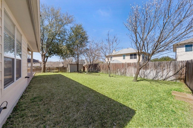 view of yard featuring an outdoor structure, a fenced backyard, and a storage shed