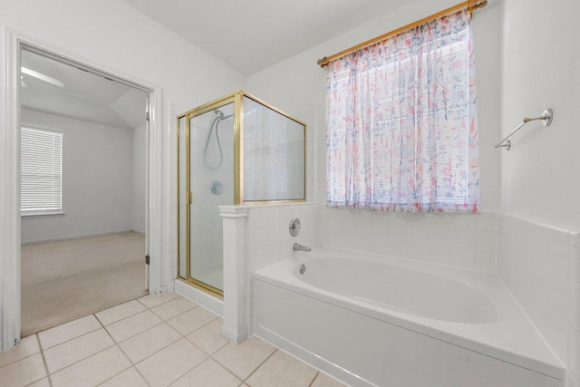 full bathroom featuring tile patterned flooring, a garden tub, and a stall shower