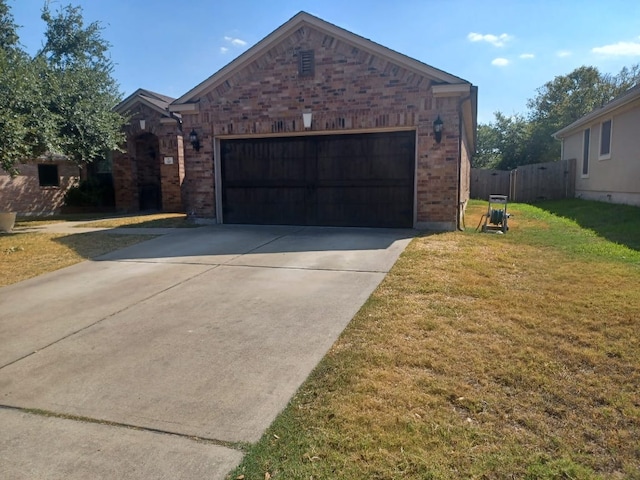 view of front of property featuring brick siding, a front lawn, fence, concrete driveway, and an attached garage