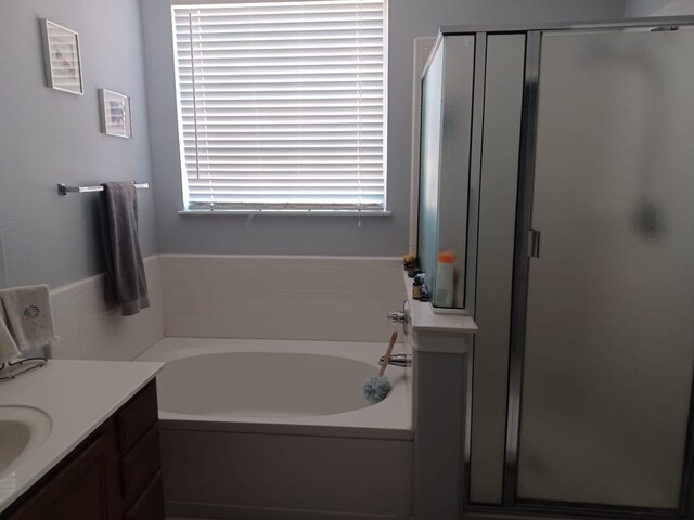 full bath featuring vanity, a bath, and a shower stall