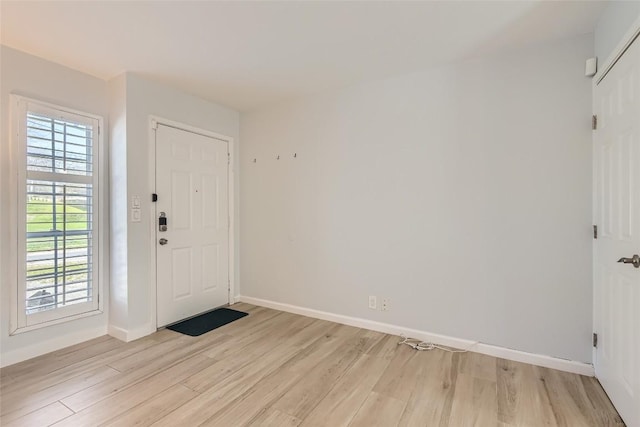 entryway with light wood-style flooring and baseboards