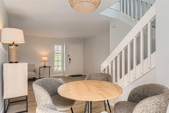 entryway with stairway, wood finished floors, and baseboards