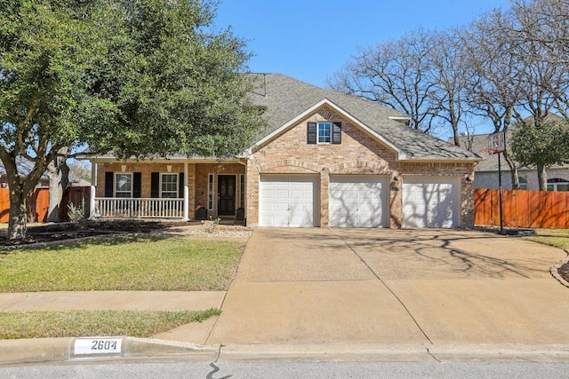 view of front of house featuring fence, driveway, covered porch, a garage, and brick siding