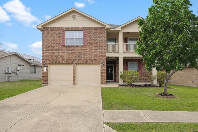 traditional-style home with a front yard, a balcony, driveway, a garage, and brick siding