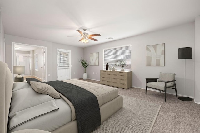 bedroom with visible vents, baseboards, light colored carpet, and ceiling fan