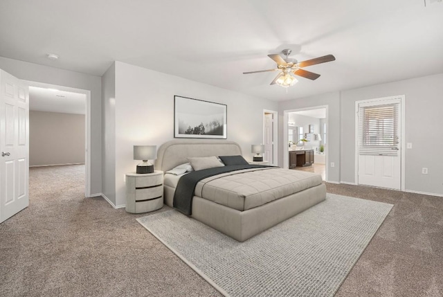 bedroom featuring a ceiling fan, baseboards, carpet floors, and connected bathroom