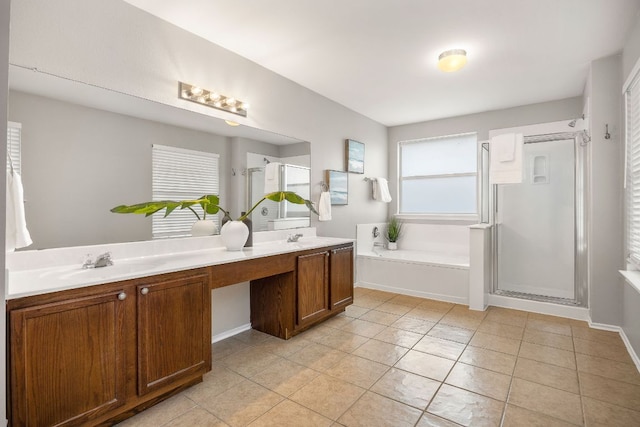 bathroom featuring double vanity, a sink, tile patterned flooring, a shower stall, and a garden tub